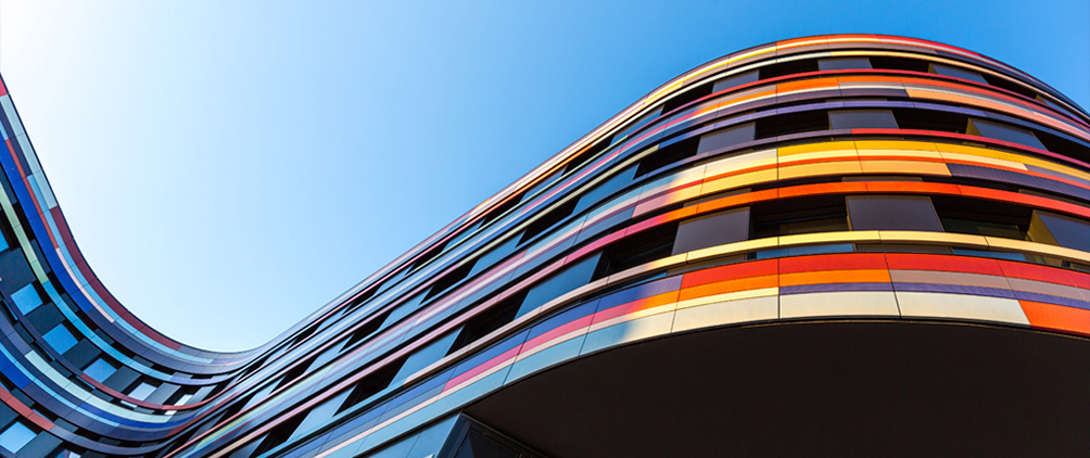 Colorful curved building facade representing securitized credit markets, mortgage-backed securities, and structured fixed income opportunities.