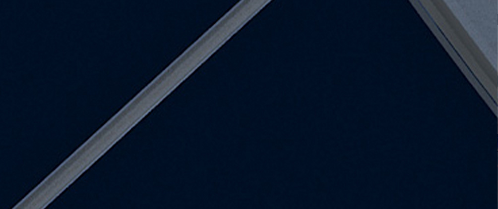 Abstract close-up of intersecting metallic beams against a dark background.