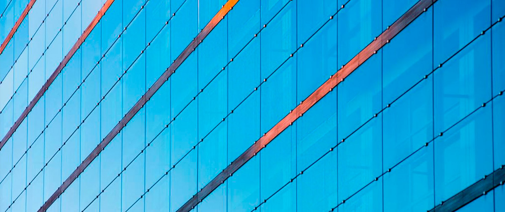 Close-up of a modern glass building with diagonal structural lines.