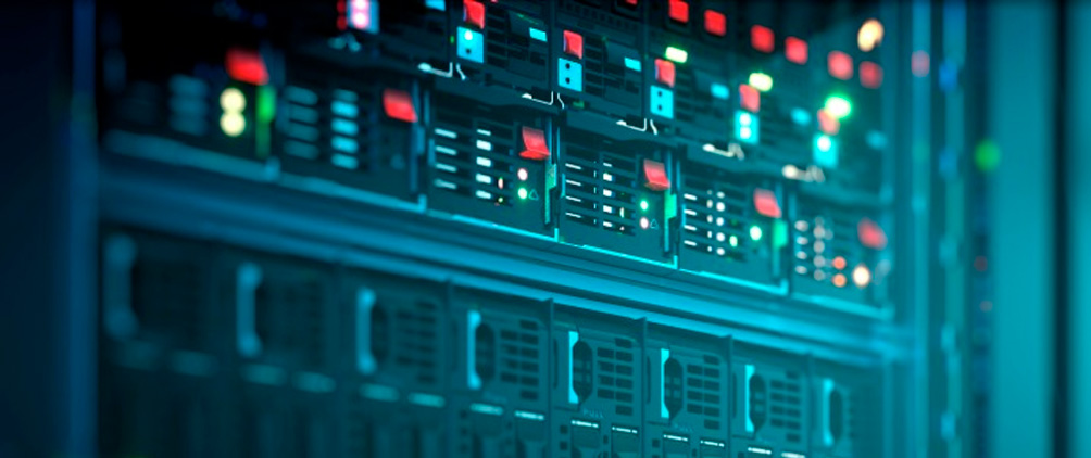 Close-up of illuminated server racks inside a data center.