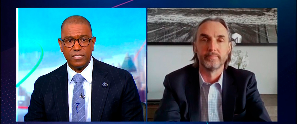 Split-screen Bloomberg TV interview with two speakers and an on-screen S&P 500 market headline.