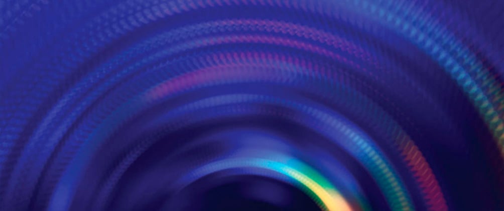 Abstract blue and purple circular light patterns.