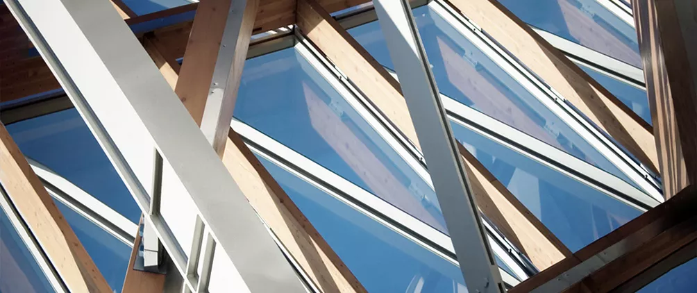 Glass and timber building structure representing mid-market infrastructure opportunities and exit options.