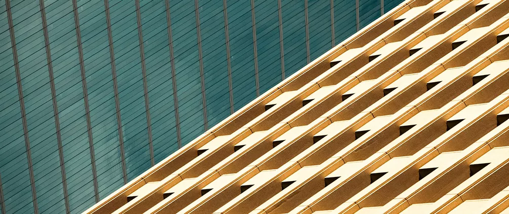 Modern glass buildings representing data center investing, real estate infrastructure, and digital infrastructure demand.