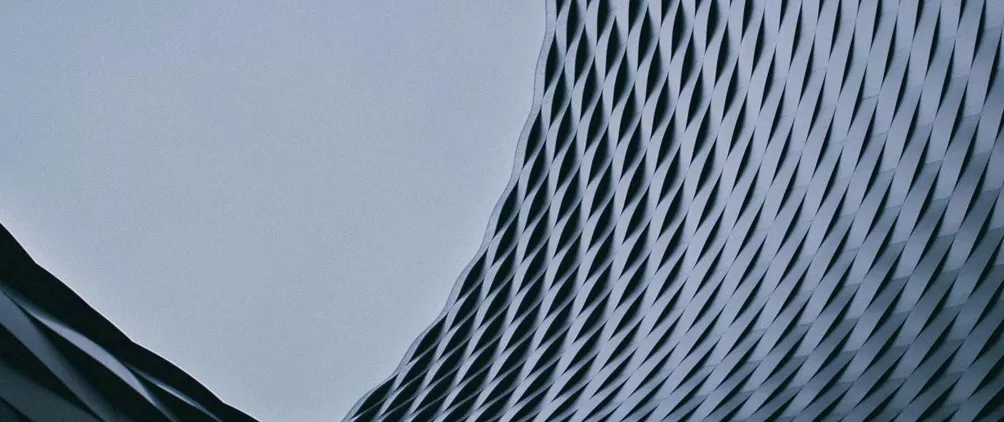 Abstract blue-gray architectural building facade representing StepStone’s Spring 2026 real estate market outlook.