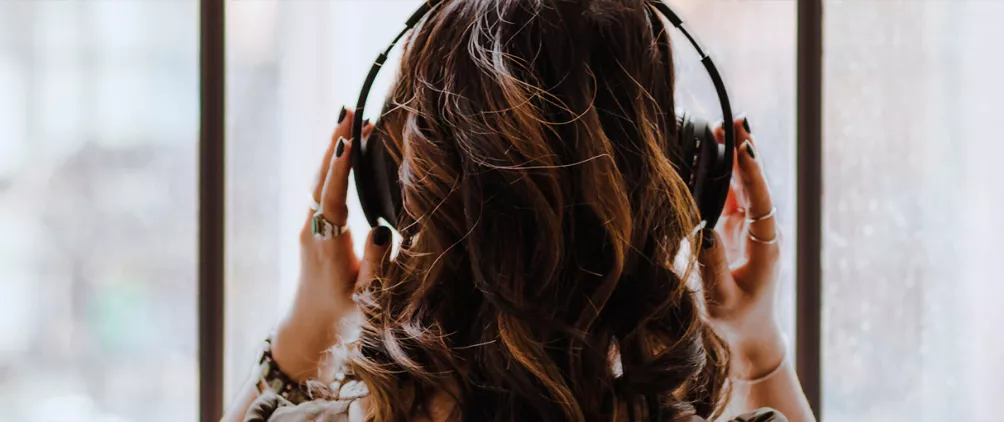 Person wearing headphones representing StepStone Group’s RPM podcast episode on UK private equity, scarcity, specialism, and succession.