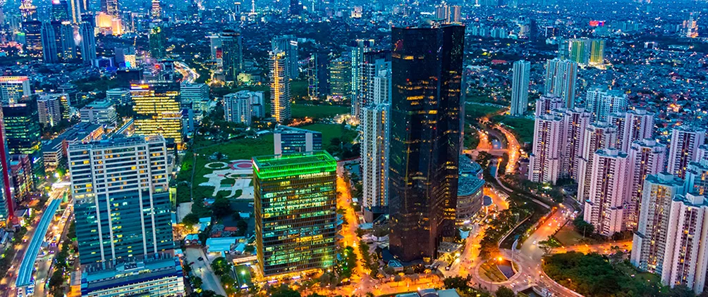 City skyline at dusk representing emerging markets, global debt and macroeconomic resilience.