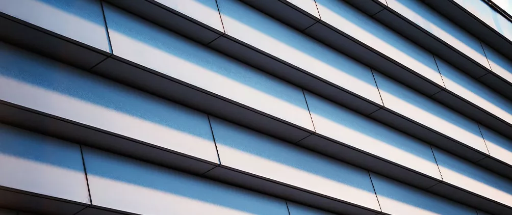 Modern building facade with layered horizontal lines representing CLO tranche thickness, structured credit and life insurer capital considerations.